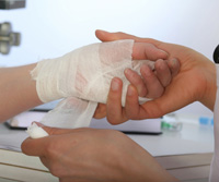 putting a bandage on a patients hand